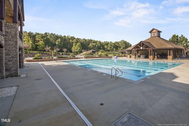 pool with a gazebo and a patio