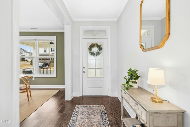 foyer entrance with crown molding, wood finished floors, and baseboards