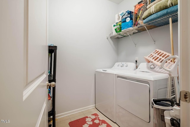 laundry room featuring washer and clothes dryer, laundry area, baseboards, and light tile patterned floors