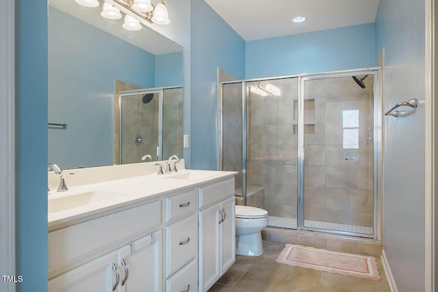 full bath featuring tile patterned flooring, toilet, double vanity, a stall shower, and a sink