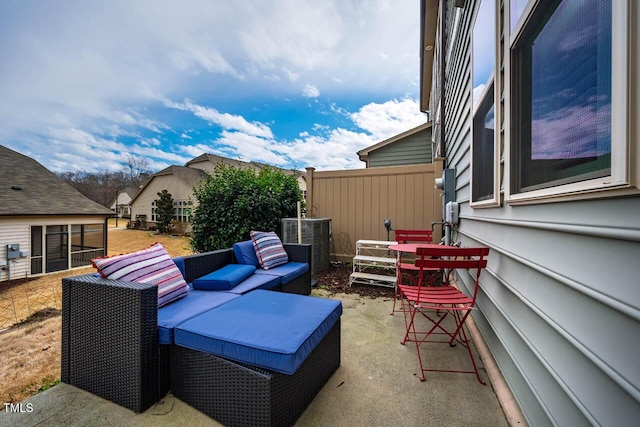 view of patio / terrace with outdoor lounge area, fence, and central AC