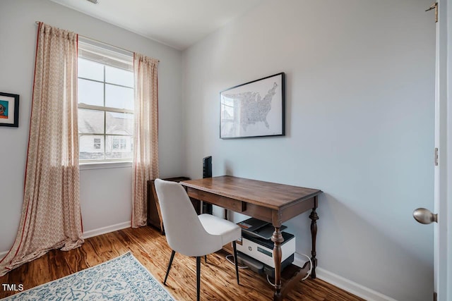 office space with wood finished floors and baseboards