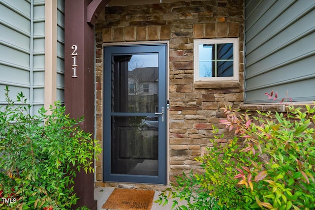 view of exterior entry with stone siding