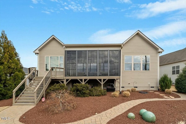 view of front of property featuring crawl space, stairs, and a sunroom