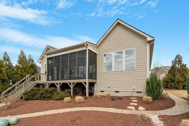 back of house featuring crawl space, stairs, and a sunroom