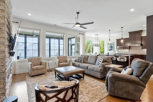 living area featuring recessed lighting, baseboards, wood finished floors, and a ceiling fan