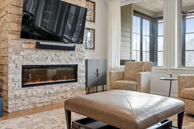 living area featuring a stone fireplace