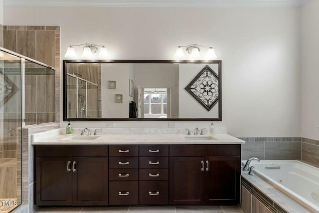 full bath with double vanity, a stall shower, and a sink