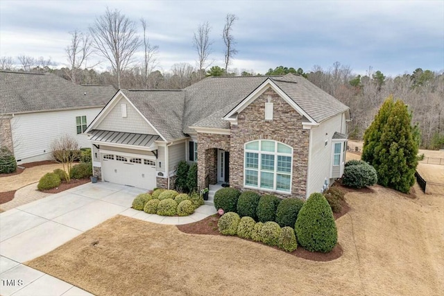 view of front facade featuring driveway, a standing seam roof, a garage, stone siding, and metal roof