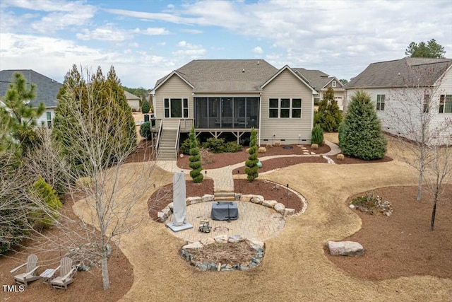 back of house with a fire pit, stairs, roof with shingles, a sunroom, and crawl space