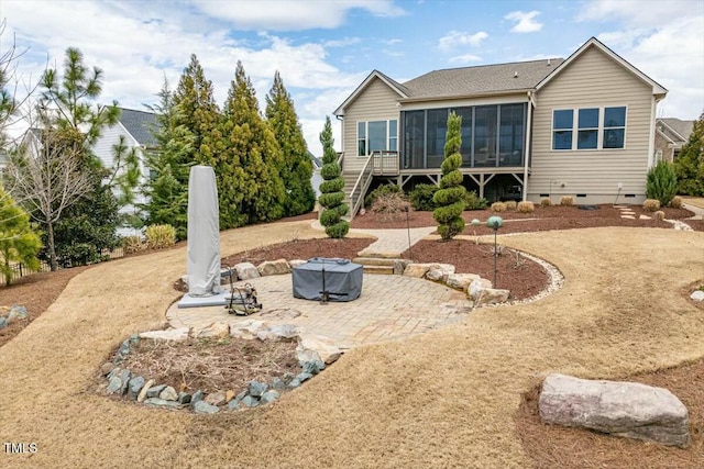 rear view of house featuring crawl space, stairway, a patio, and a sunroom