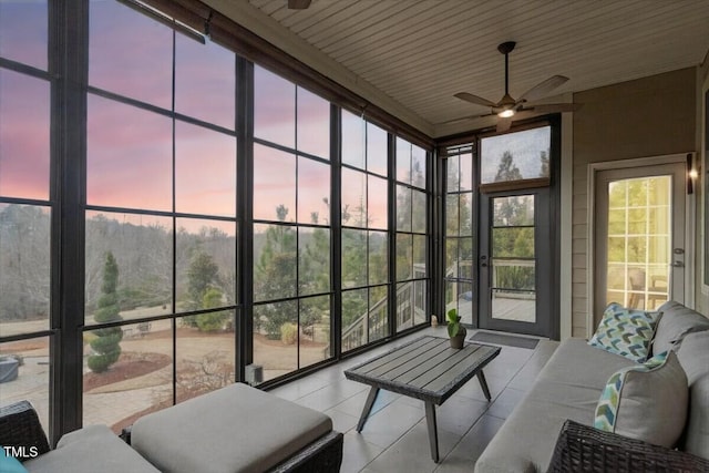 sunroom / solarium featuring ceiling fan