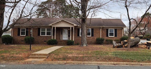 view of front of home with brick siding and crawl space