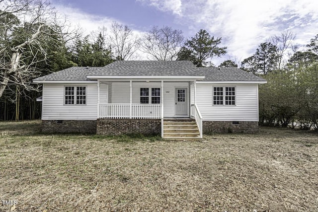 view of front facade featuring crawl space, a porch, and roof with shingles