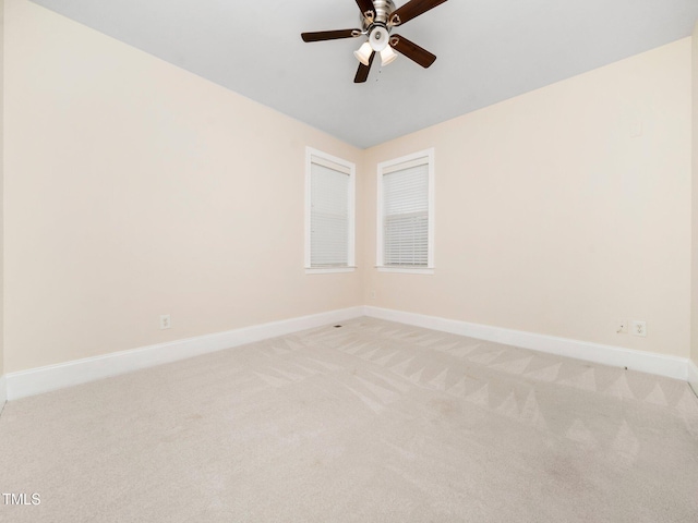 unfurnished room with light carpet, a ceiling fan, and baseboards