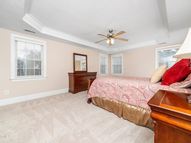 bedroom featuring visible vents, crown molding, a raised ceiling, and carpet floors