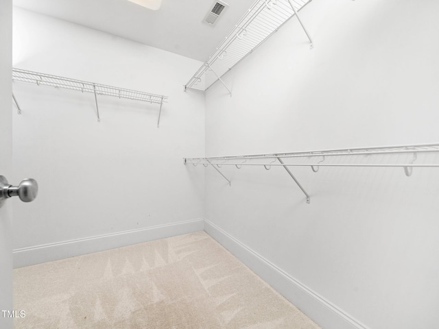 walk in closet featuring visible vents and carpet floors