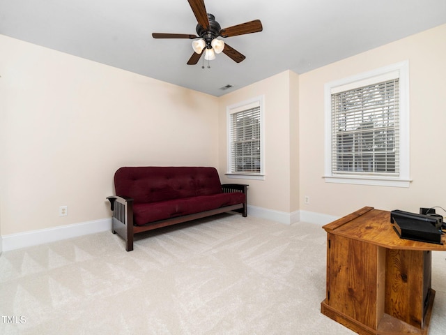 sitting room with baseboards, carpet floors, visible vents, and ceiling fan