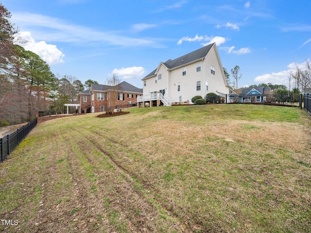 view of yard with a deck and a fenced backyard