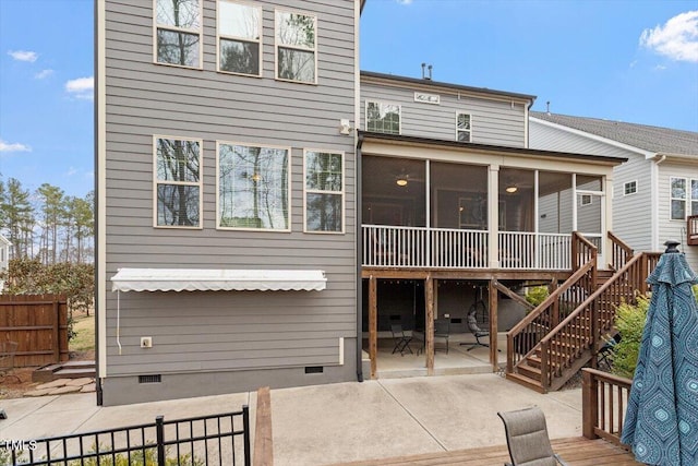 rear view of property featuring fence, stairway, a sunroom, crawl space, and a patio area