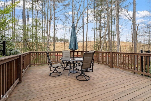 wooden terrace featuring outdoor dining space