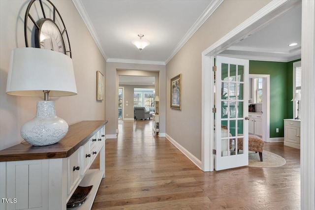 foyer entrance with french doors, baseboards, light wood-style flooring, and ornamental molding