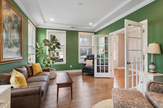 living room with visible vents, crown molding, baseboards, french doors, and wood finished floors