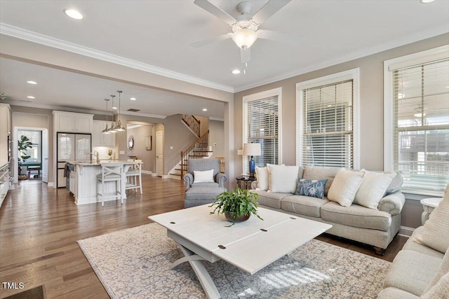 living area with recessed lighting, ornamental molding, stairs, and wood finished floors