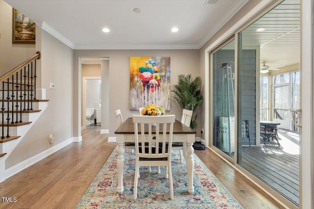 dining area featuring recessed lighting, crown molding, baseboards, and wood finished floors