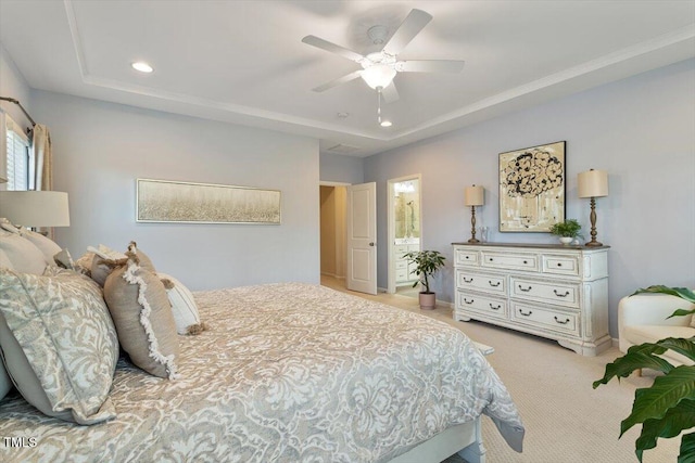 carpeted bedroom with recessed lighting, a tray ceiling, and a ceiling fan