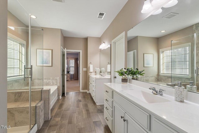 full bathroom with a sink, visible vents, and a shower stall