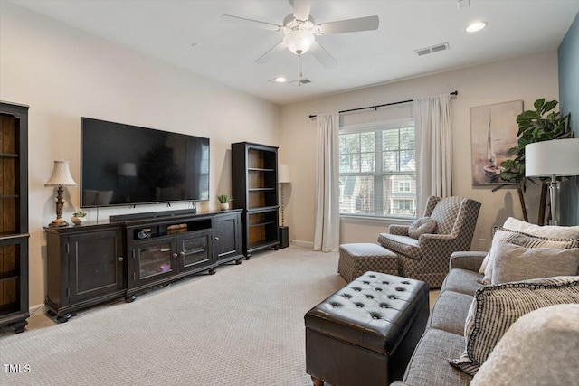 living area featuring visible vents, a ceiling fan, recessed lighting, baseboards, and light colored carpet