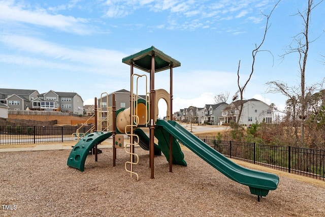 community play area featuring a residential view and fence