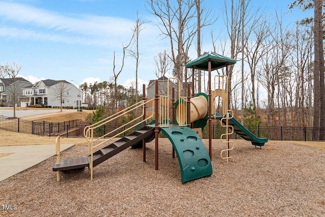 community playground with a residential view and fence