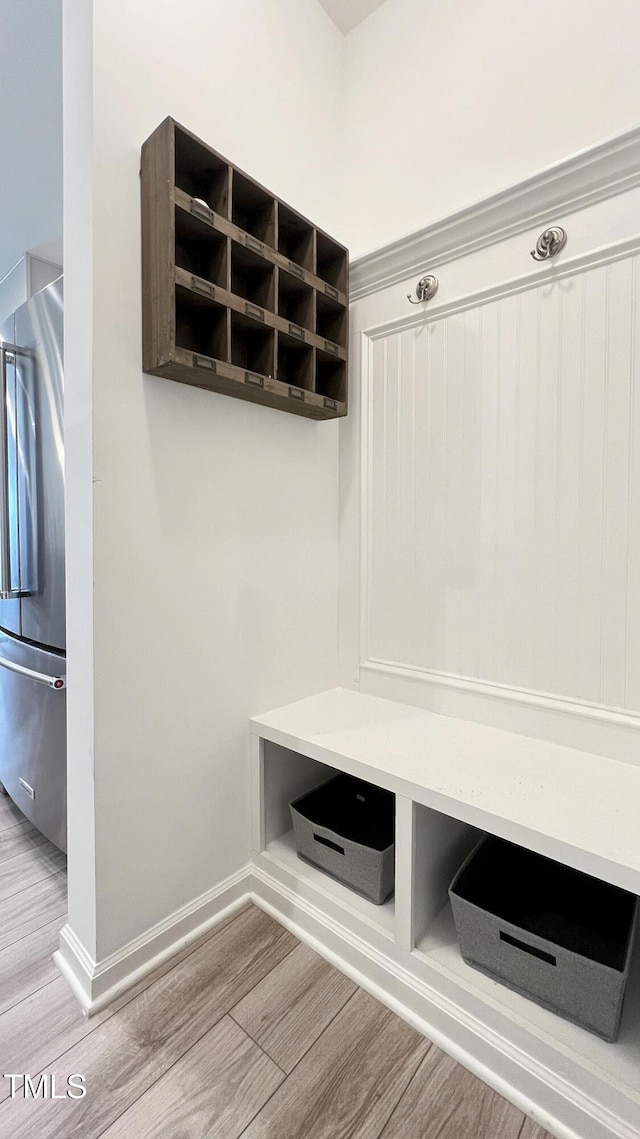 mudroom featuring wood finished floors and baseboards