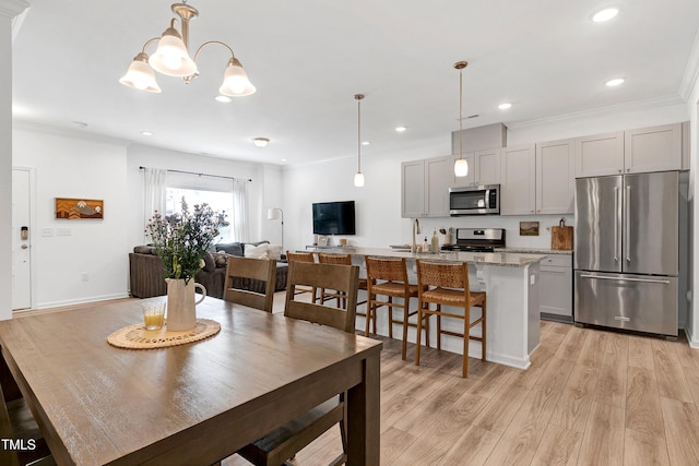 dining space featuring crown molding, recessed lighting, and light wood-type flooring