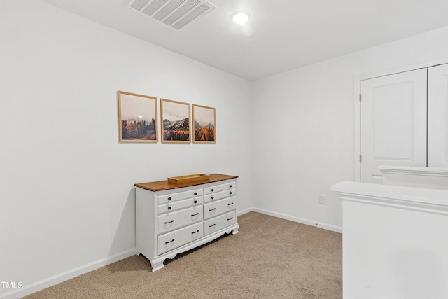 bedroom featuring baseboards, visible vents, and light carpet