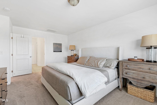 bedroom with visible vents and carpet