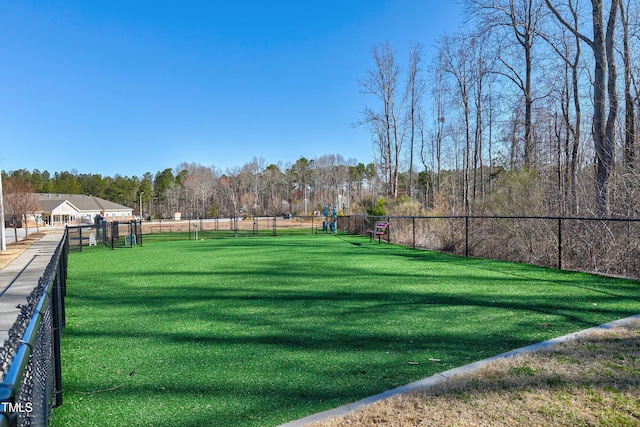 view of home's community featuring fence and a lawn