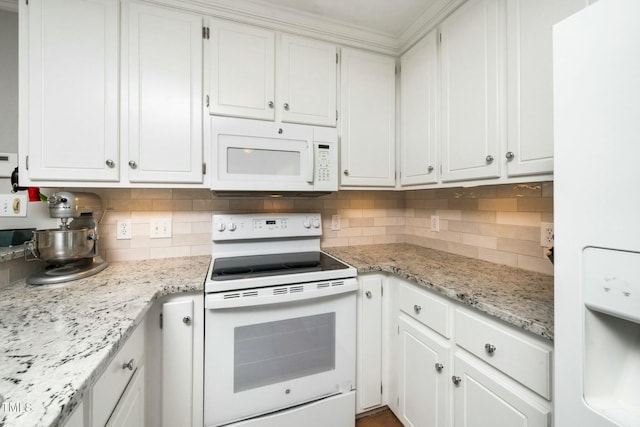 kitchen with light stone counters, white appliances, backsplash, and white cabinetry