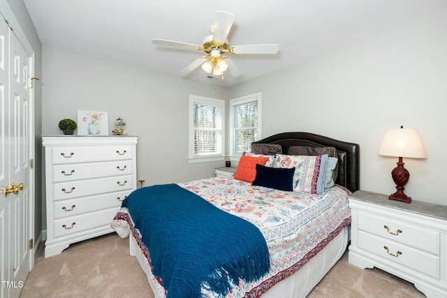 bedroom featuring light colored carpet and ceiling fan