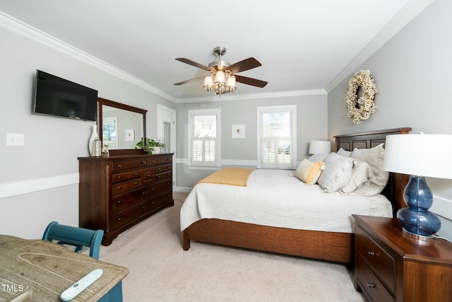 bedroom with light colored carpet, ornamental molding, and a ceiling fan