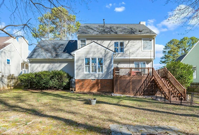 back of property featuring a lawn, a deck, stairs, and fence