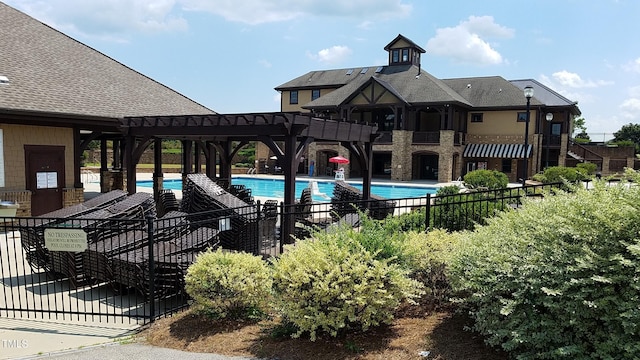 pool with a patio area and fence