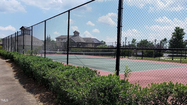 view of sport court featuring fence