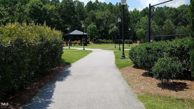 view of community with a yard and driveway