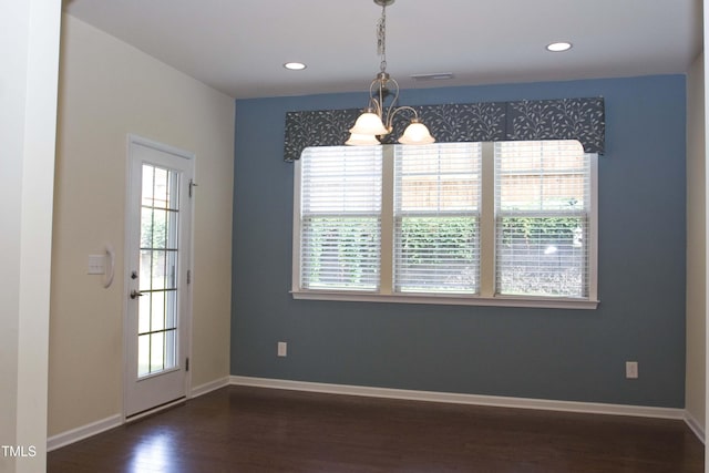 unfurnished dining area with baseboards, visible vents, recessed lighting, dark wood-type flooring, and a notable chandelier