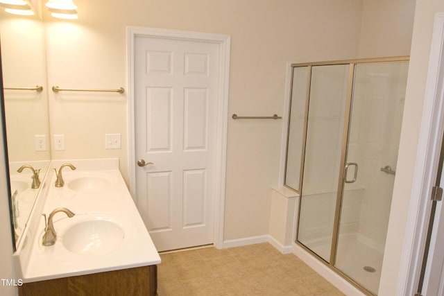 bathroom with a sink, double vanity, and a shower stall