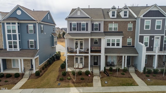 multi unit property featuring a balcony and covered porch