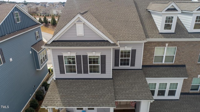 view of front of home with a residential view and roof with shingles